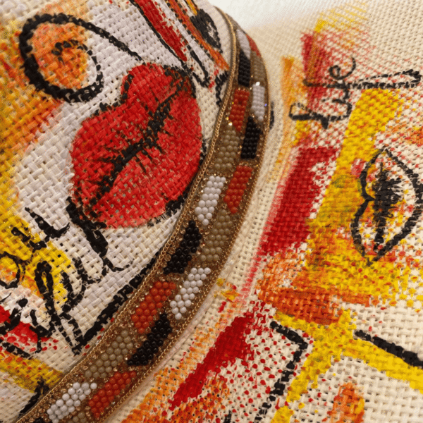 Close-up of lips and eyes pop art painting on straw hat